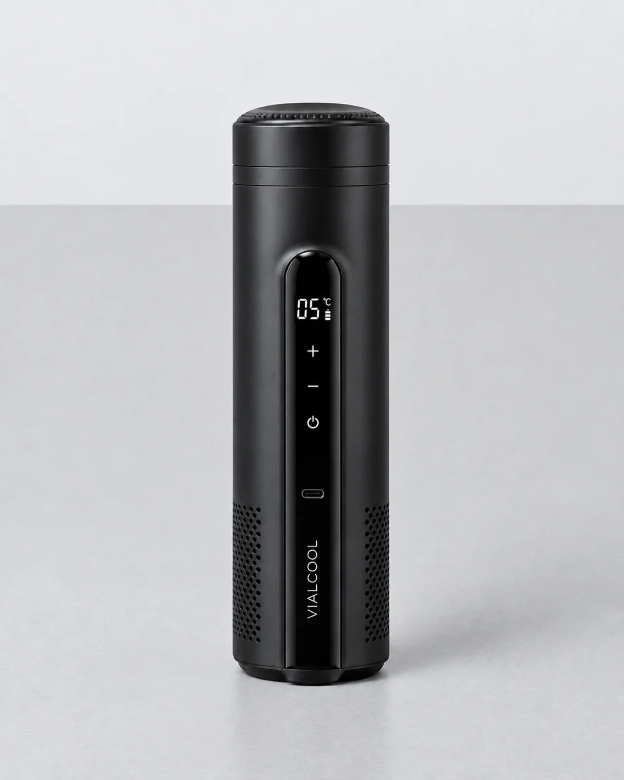 The VialCool Ultra standing upright on a light grey table, seen from the front: the display reading 05°C, plus, minus and power controls, and the VIALCOOL wordmark on the lower strip